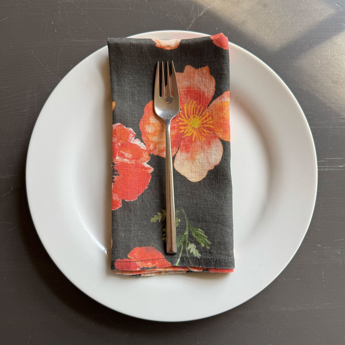 European Linen napkin with an Ember Poppies pattern on black olive