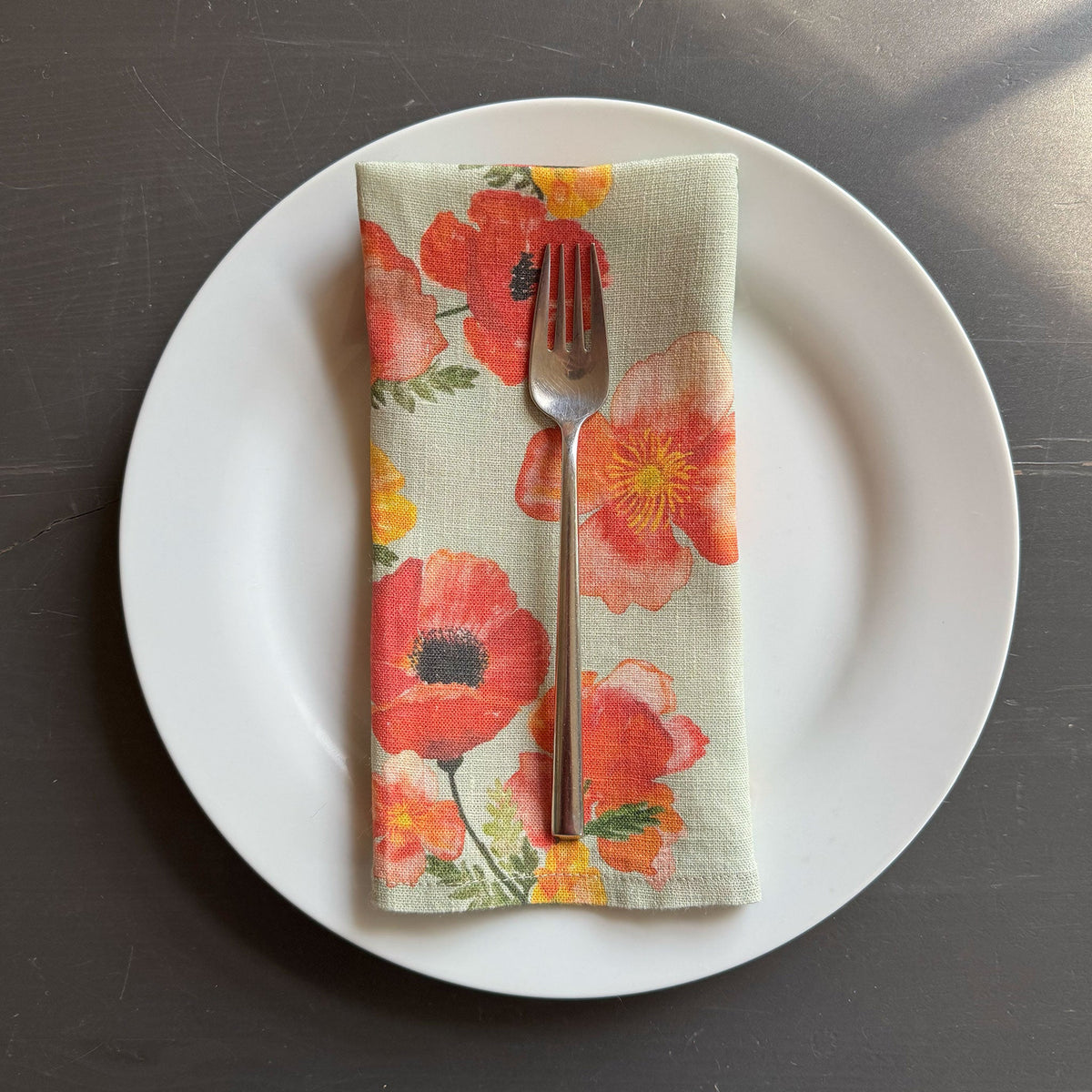 European Linen napkin with an Ember Poppies pattern on urban nature