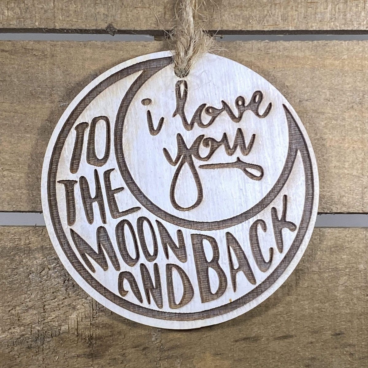 Hand-painted wooden love you to the moon and back Christmas ornament featuring a crescent moon design with heartfelt lettering and celestial details, sentimental holiday decor for couples and meaningful gift-giving by Cate’s Concepts