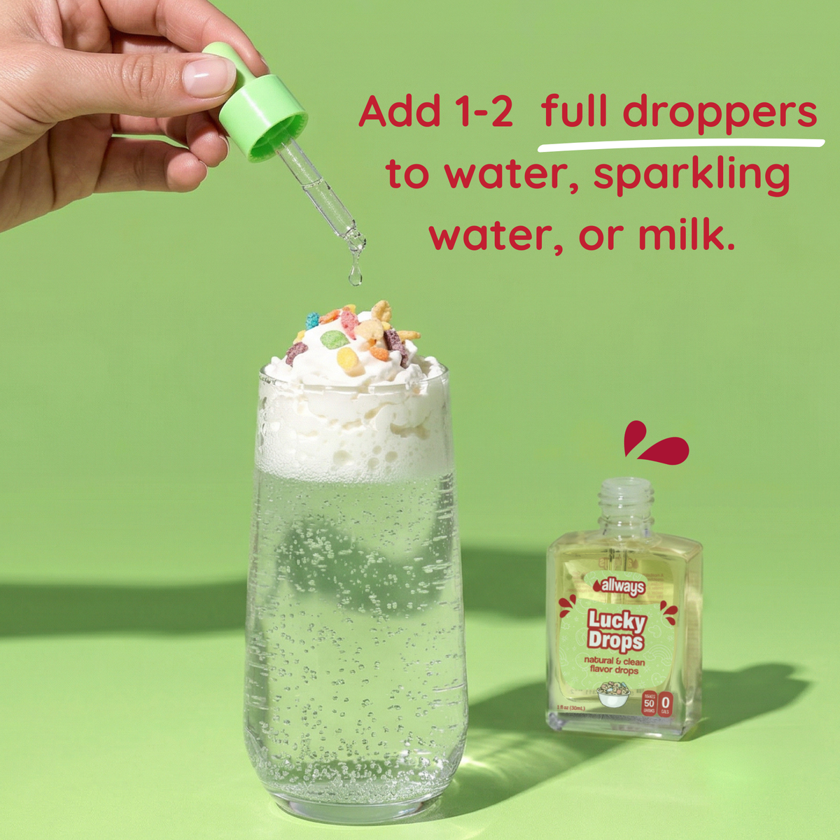 Hand dropping a green dropper into a glass of water with whipped cream and sprinkles, next to a bottle labeled &