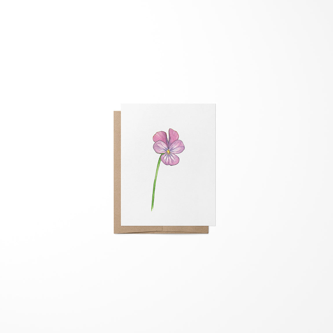 A greeting card featuring a miniature painting of a purple flower on a white background, with a Kraft envelope.