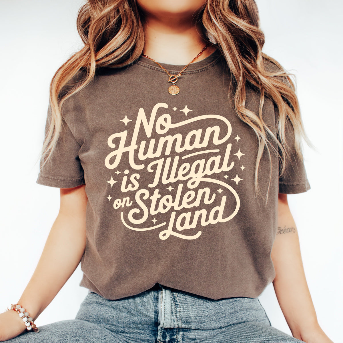 no human is illegal on stolen land graphic tee