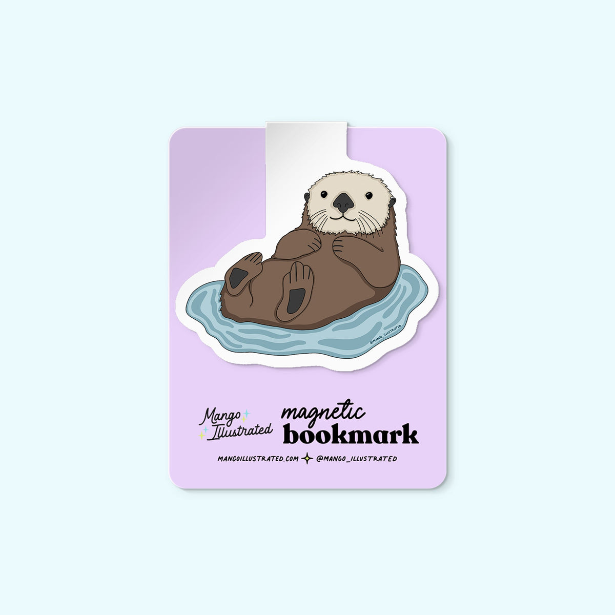 Otter magnetic bookmark detail — cute illustrated otter page marker on a book by indie artist MangoIllustrated