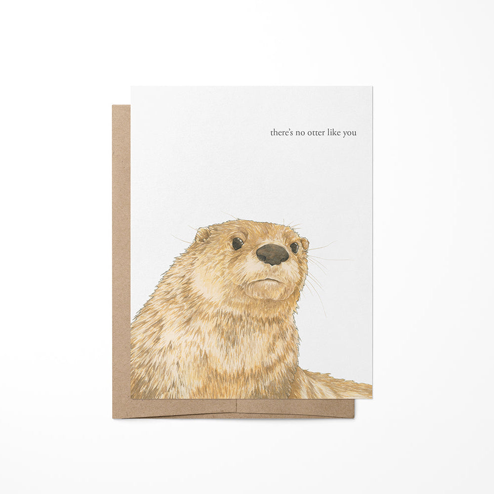 A greeting card featuring a watercolor painting of an otter on the front, with a blank inside and a kraft envelope.