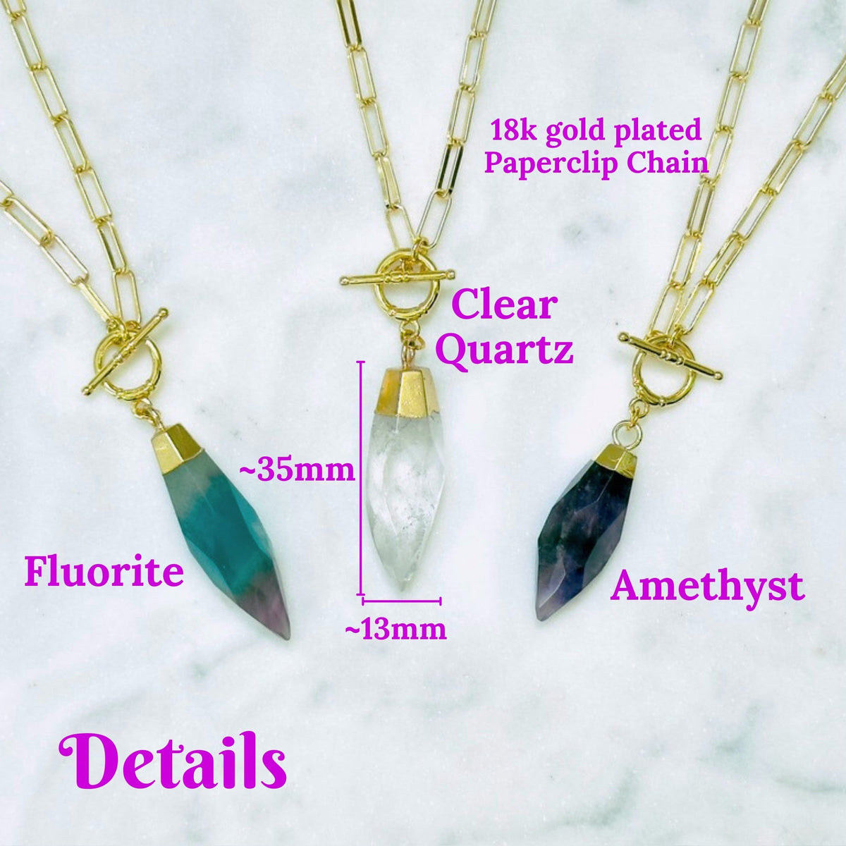 Three gold-plated paperclip chain necklaces with crystal pendants are displayed on a white marble background with pink text labels reading &