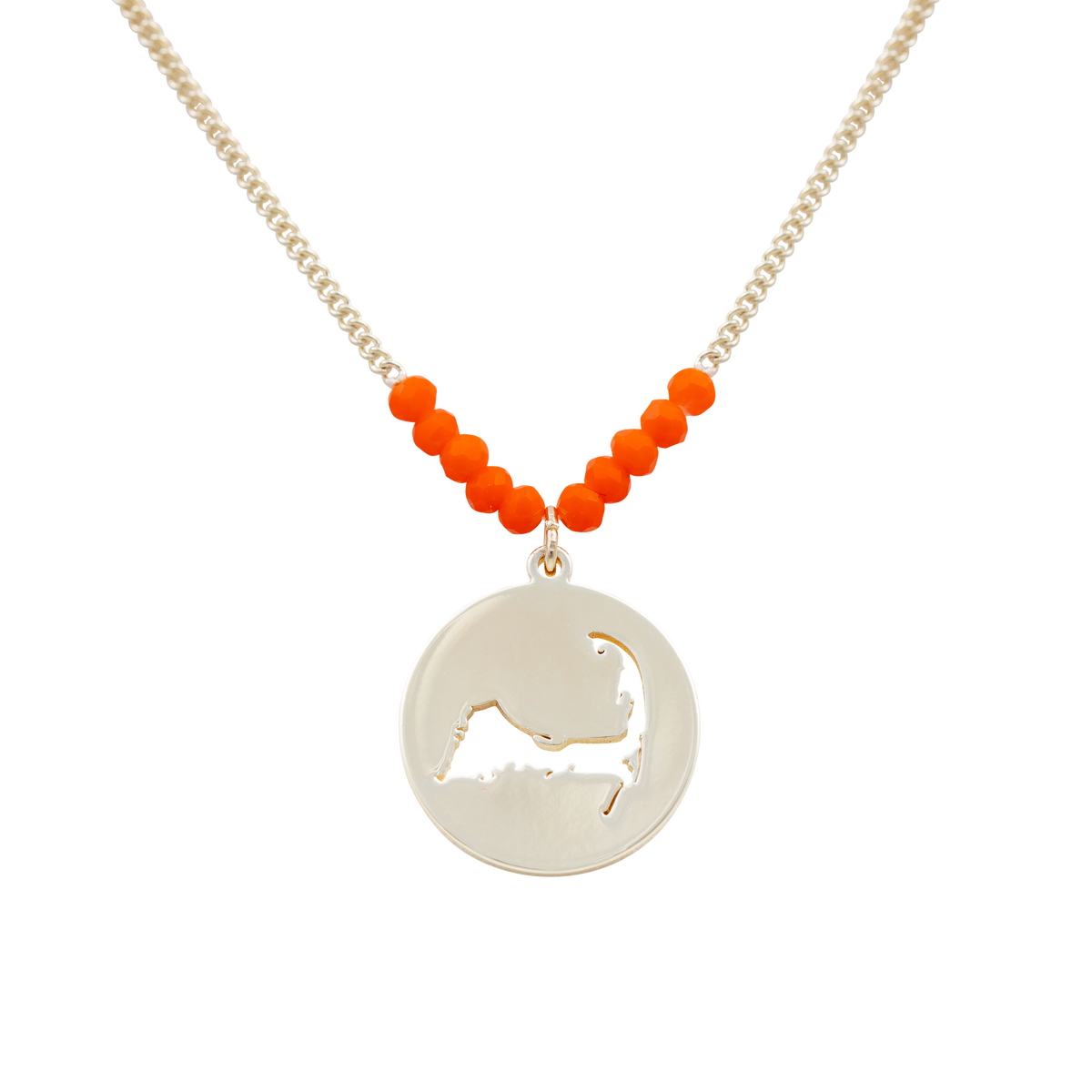 the beach and back cape cod necklace in gold with coral beads at center of chain and coin shape pendant with cutout silhouette of cape cod