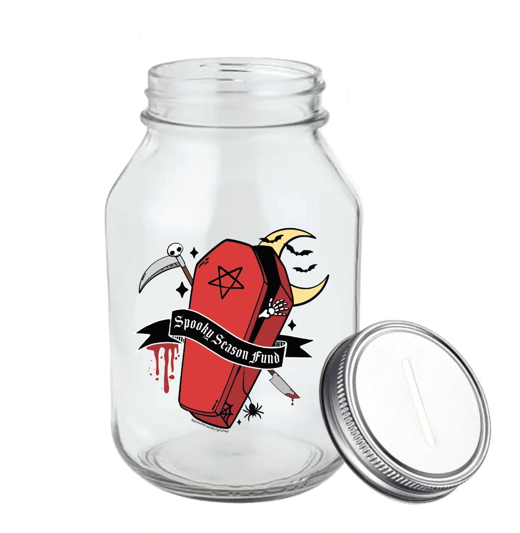 A clear glass mason jar with a silver metal lid, featuring a gothic coffin graphic, with dripping blood, moon, scythe, bats, pentagram, spider, and a moon with the text &