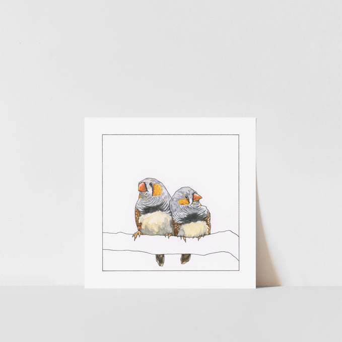 A framed art print of two finches perched on a branch, with a white background.