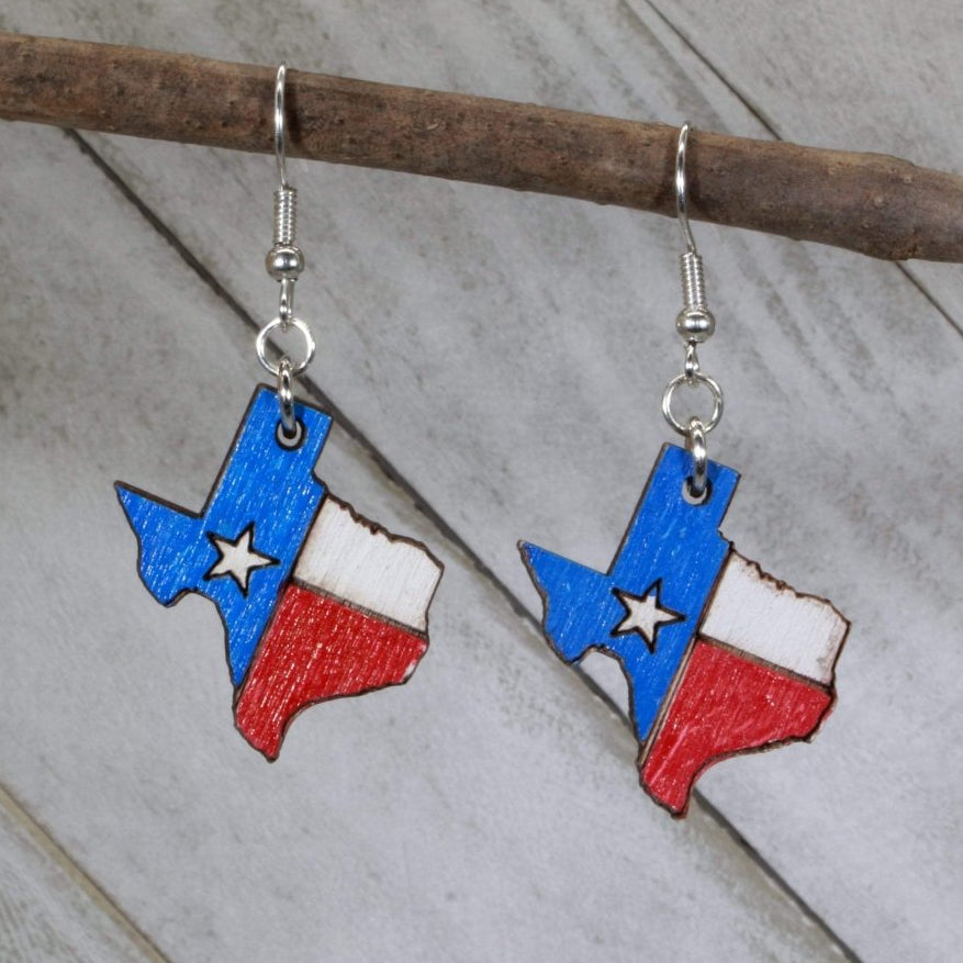 Hand-painted wooden Texas state flag dangle earrings with bold red white blue design and hypoallergenic sterling silver hooks, lightweight Texas flag statement jewelry earrings for state pride and patriotic style
