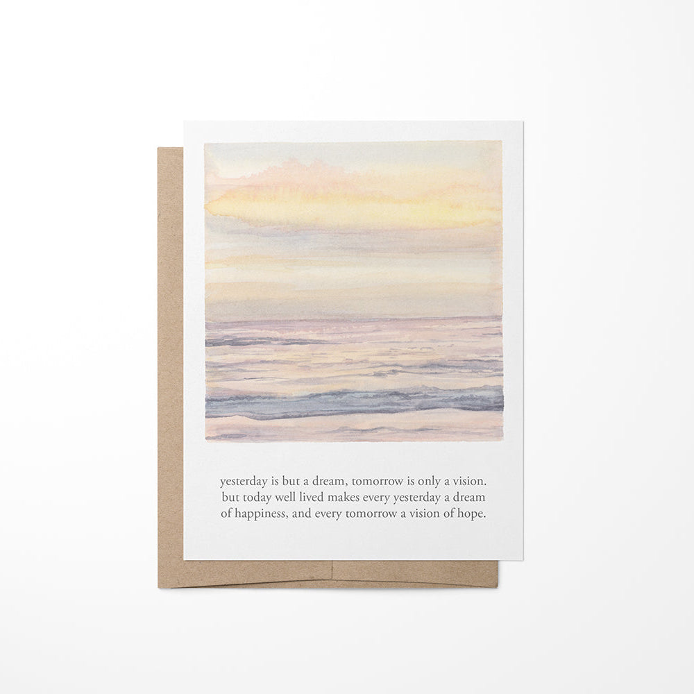 A greeting card with a dream sunset watercolor painting and a quote by Kalidasa on the back.