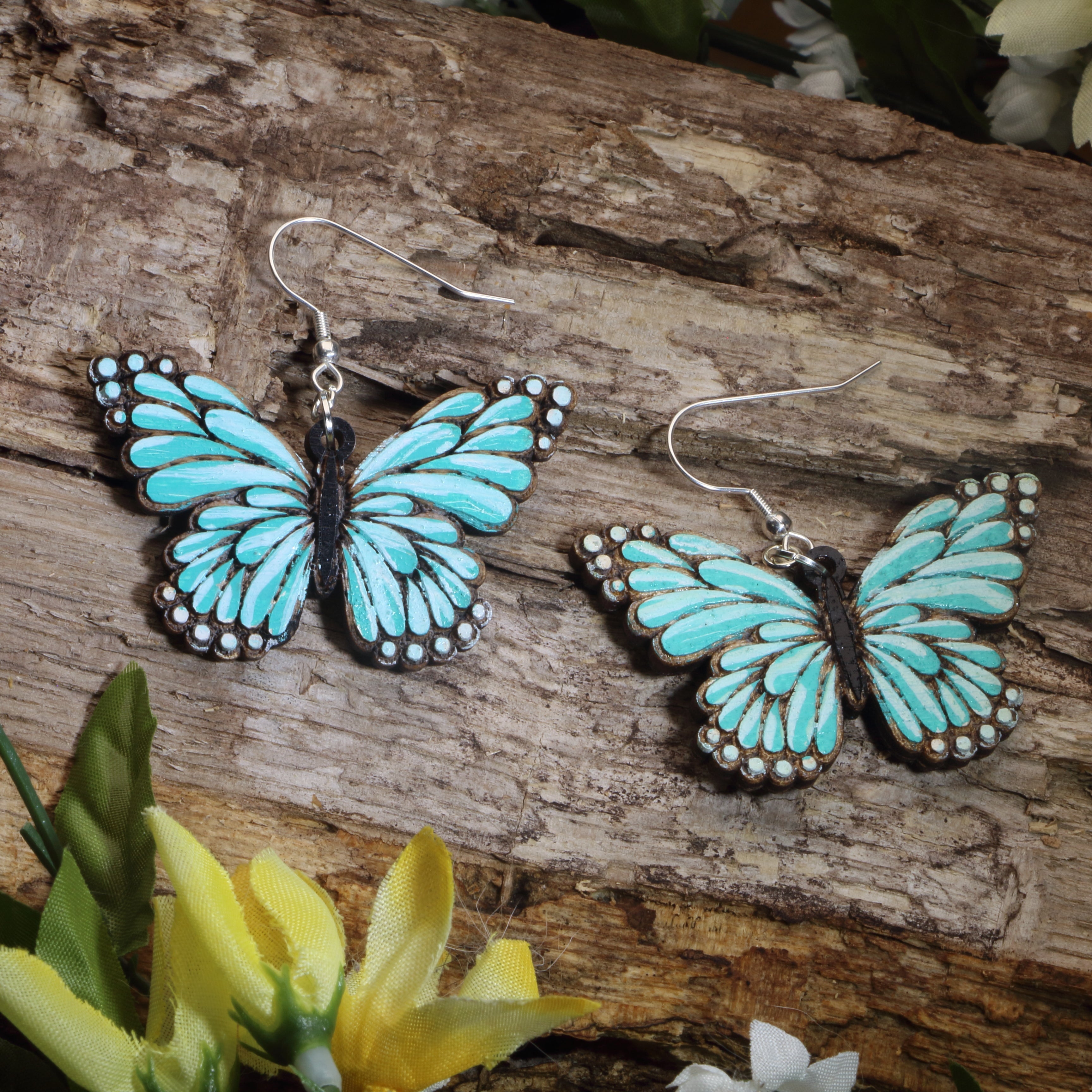 Hand-painted wooden turquoise butterfly dangle earrings with vibrant nature-inspired wing design and hypoallergenic sterling silver hooks, lightweight butterfly jewelry for garden lovers and whimsical everyday style by Cate’s Concepts.