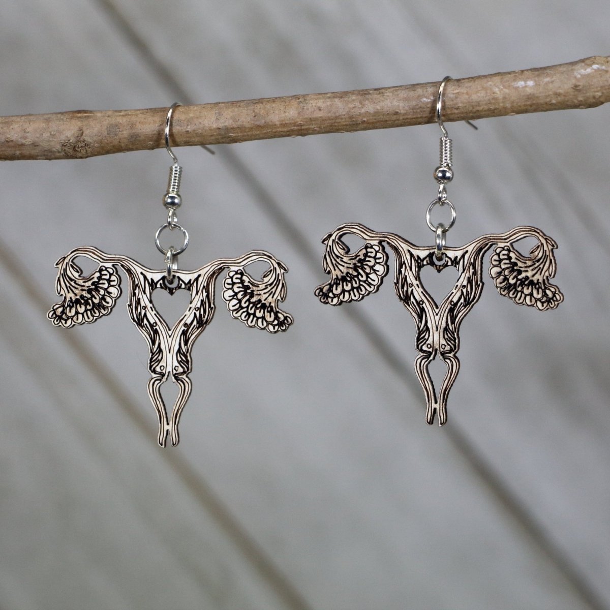Hand-painted wooden uterus dangle earrings with bold anatomical design and hypoallergenic sterling silver hooks, feminist statement jewelry earrings for reproductive rights and anatomy lovers