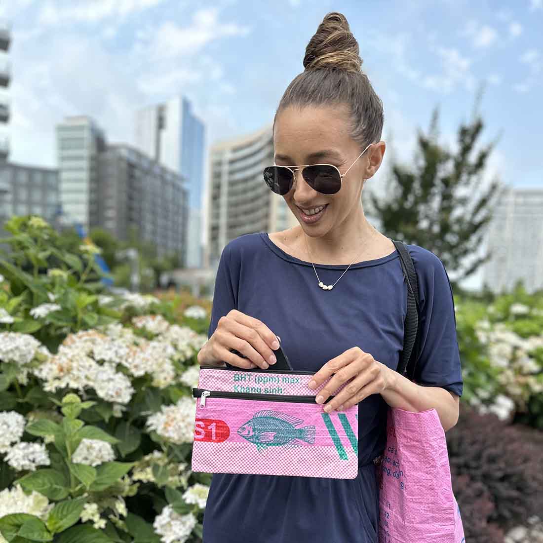 woman holding pink cosmetic case