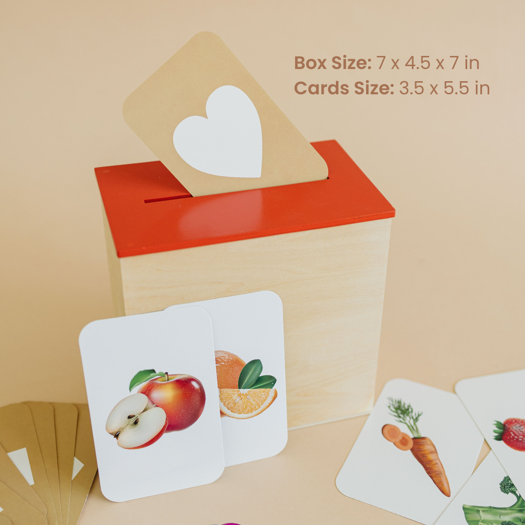 Wooden box with red top, featuring cards with fruit and vegetable flashcards on a beige background.