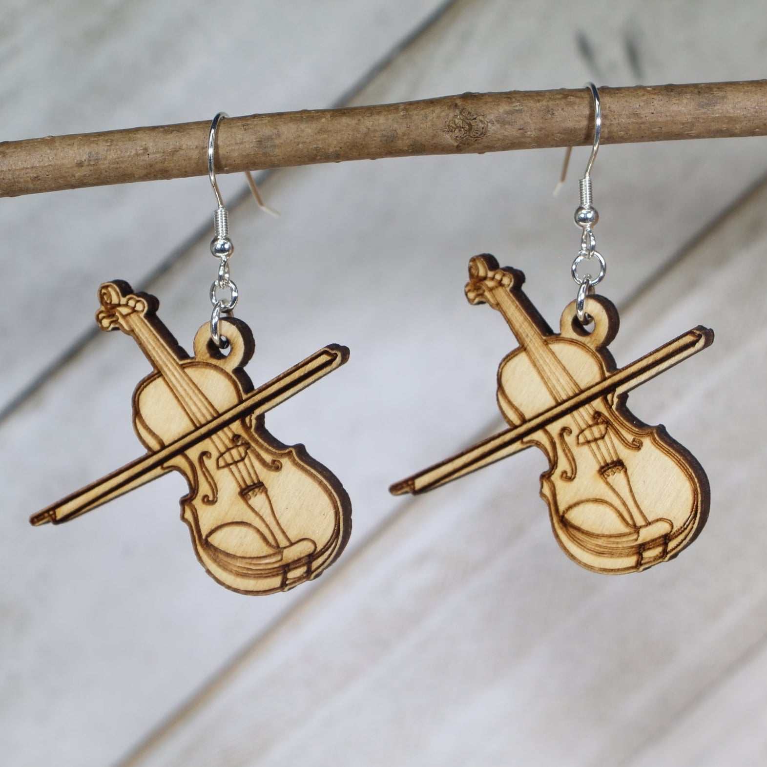 Hand-painted wooden violin dangle earrings featuring a detailed string instrument design with curved body and fine tuning details and hypoallergenic sterling silver hooks, lightweight jewelry for musicians and orchestra lovers by Cate’s Concepts