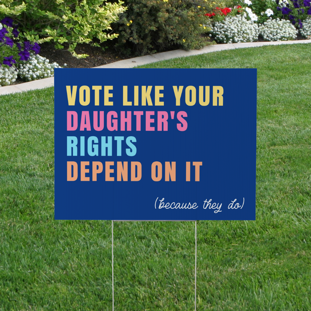 Blue political yard sign reading "Vote Like Your Daughter&