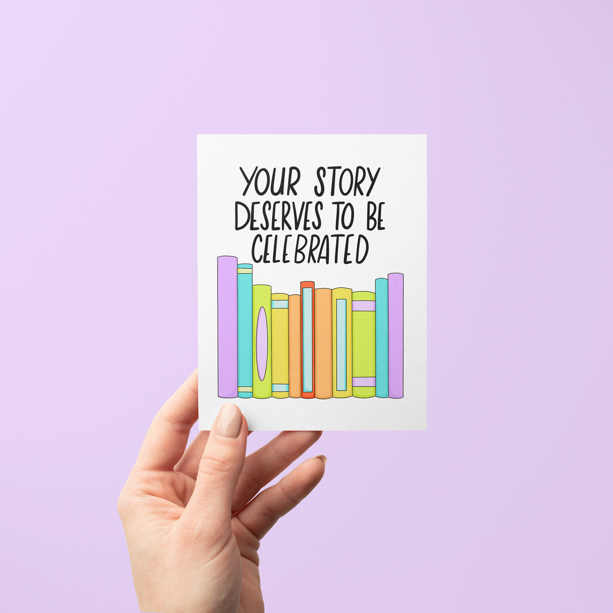 Your Story Deserves to be Celebrated Pride Card flat lay — bookish LGBTQ celebration card by indie artist MangoIllustrated