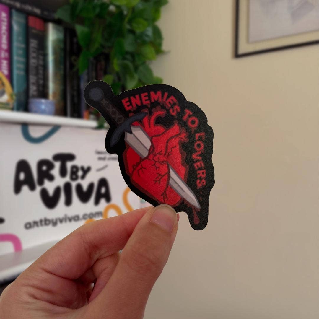 Hand holding a sticker with &