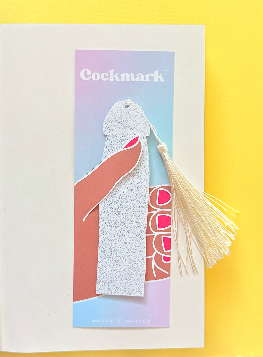 Cockmark product on a colorful card with tassel on a yellow background
