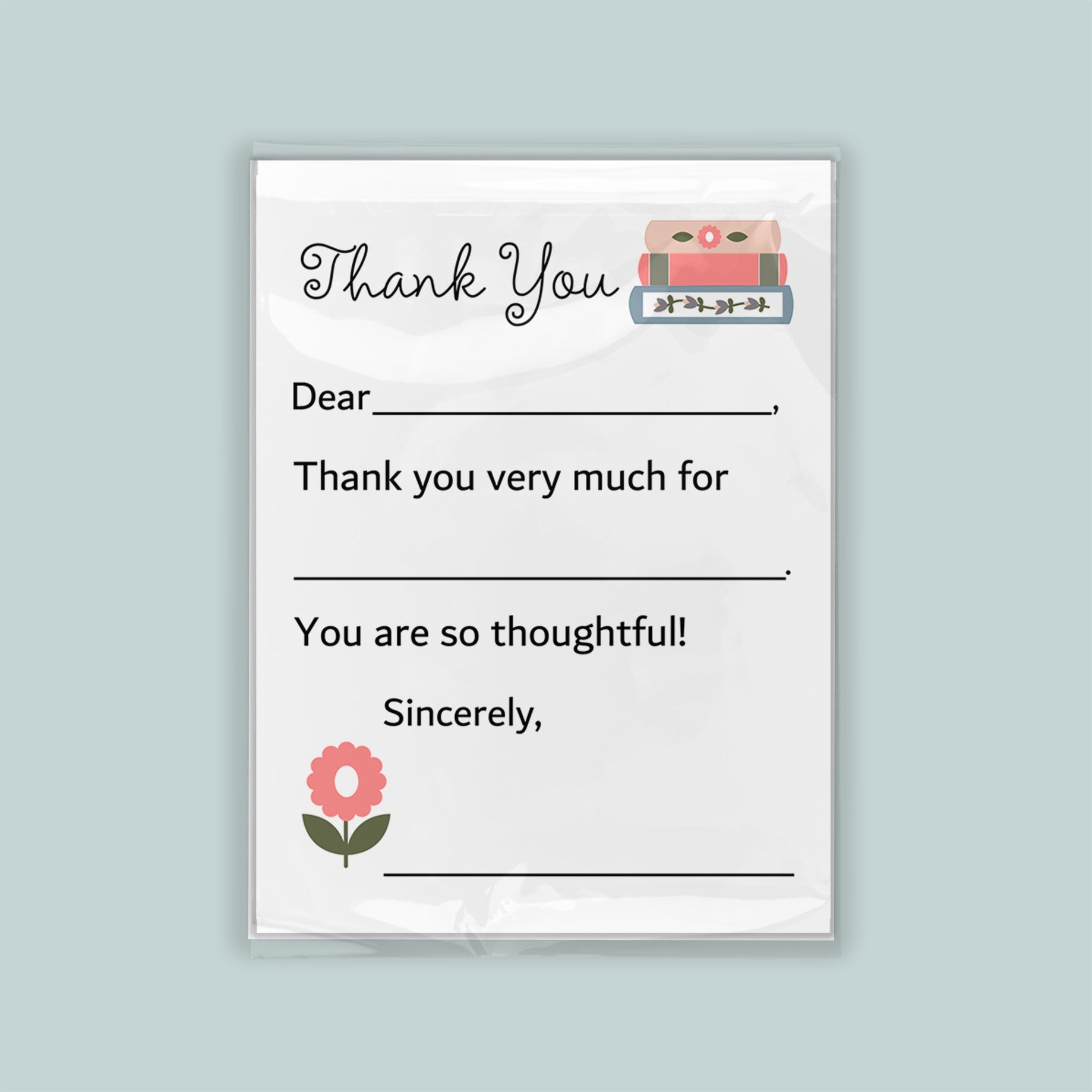 The image is a white thank you card with a pink flower and a stack of books as decorations. The card has a blank space for a message and a blank space for a signature.