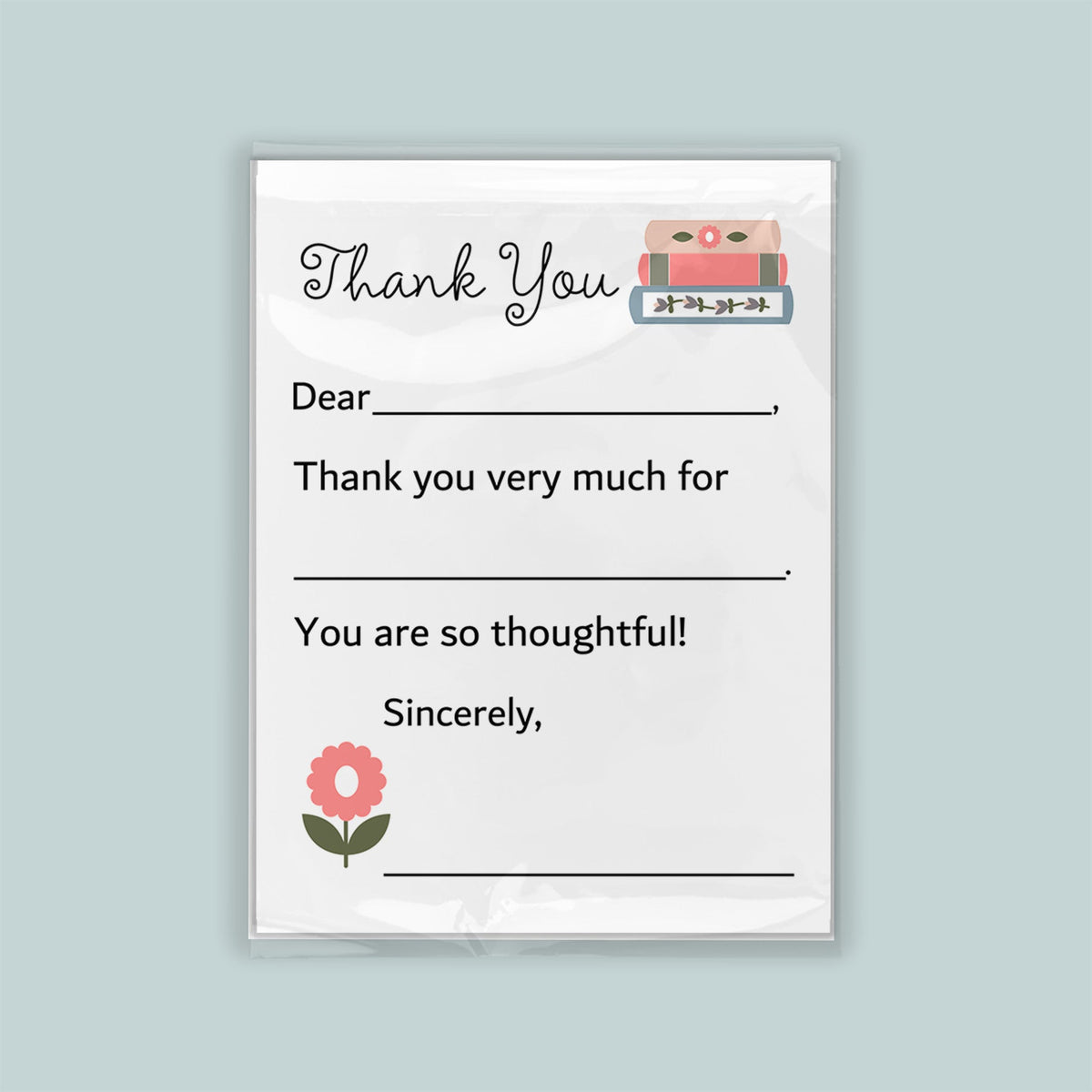 The image is a white thank you card with a pink flower and a stack of books as decorations. The card has a blank space for a message and a blank space for a signature.