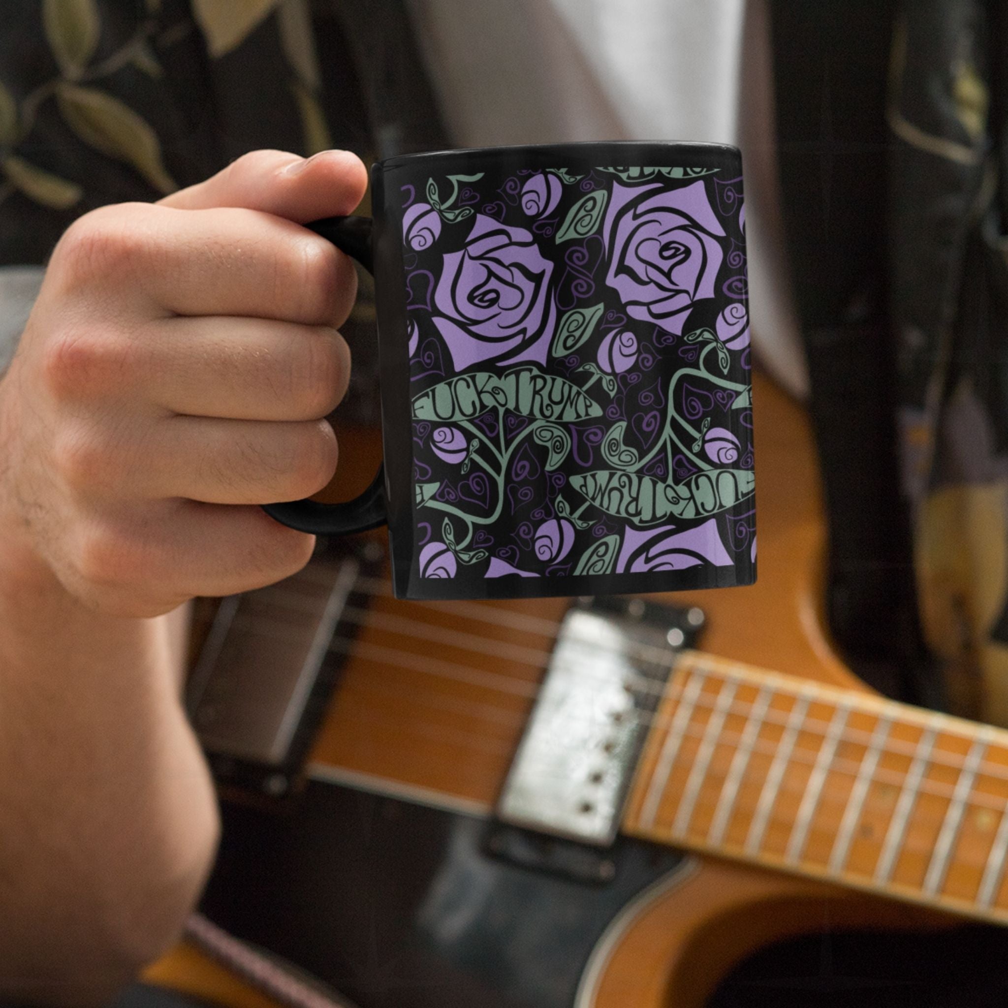 Person playing a guitar drinking from fuck trump floral gothic coffee mug