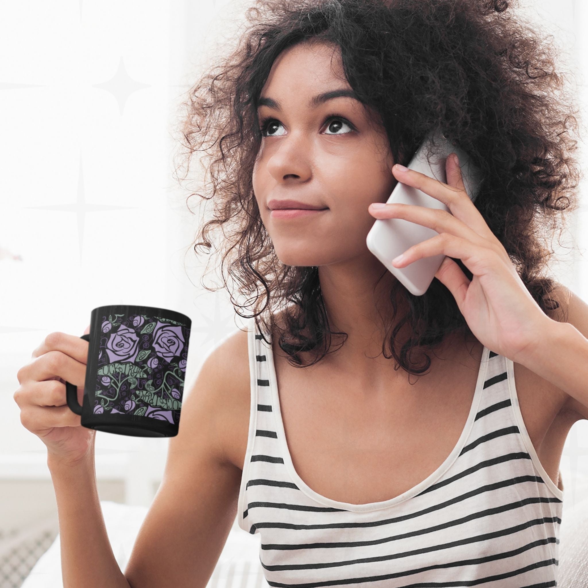women on phone drinking from a dark romantic floral mug with hidden message, "fuck trump"