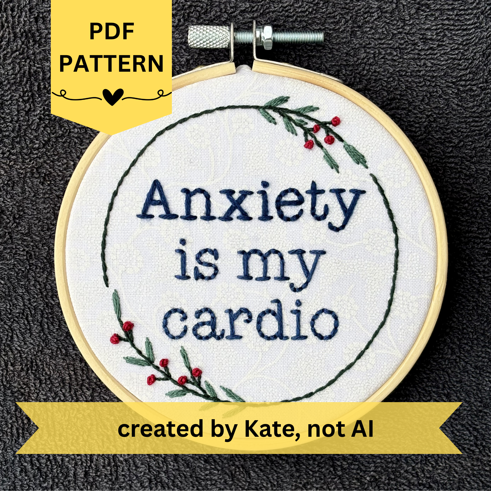 PDF pattern created by Kate, not AI. "Anxiety is my cardio." Quote hand embroidered in dark blue in typewriter font. Text is surrounded by minimalist floral wreath of dark green stems, green leaves, and red buds.. Fabric is white-on-white cotton. Displayed as wall art in a light wooden embroidery hoop.