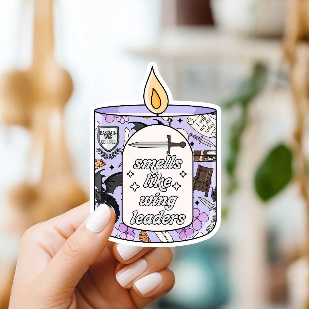 Hand holding a sticker with a candle design and text &