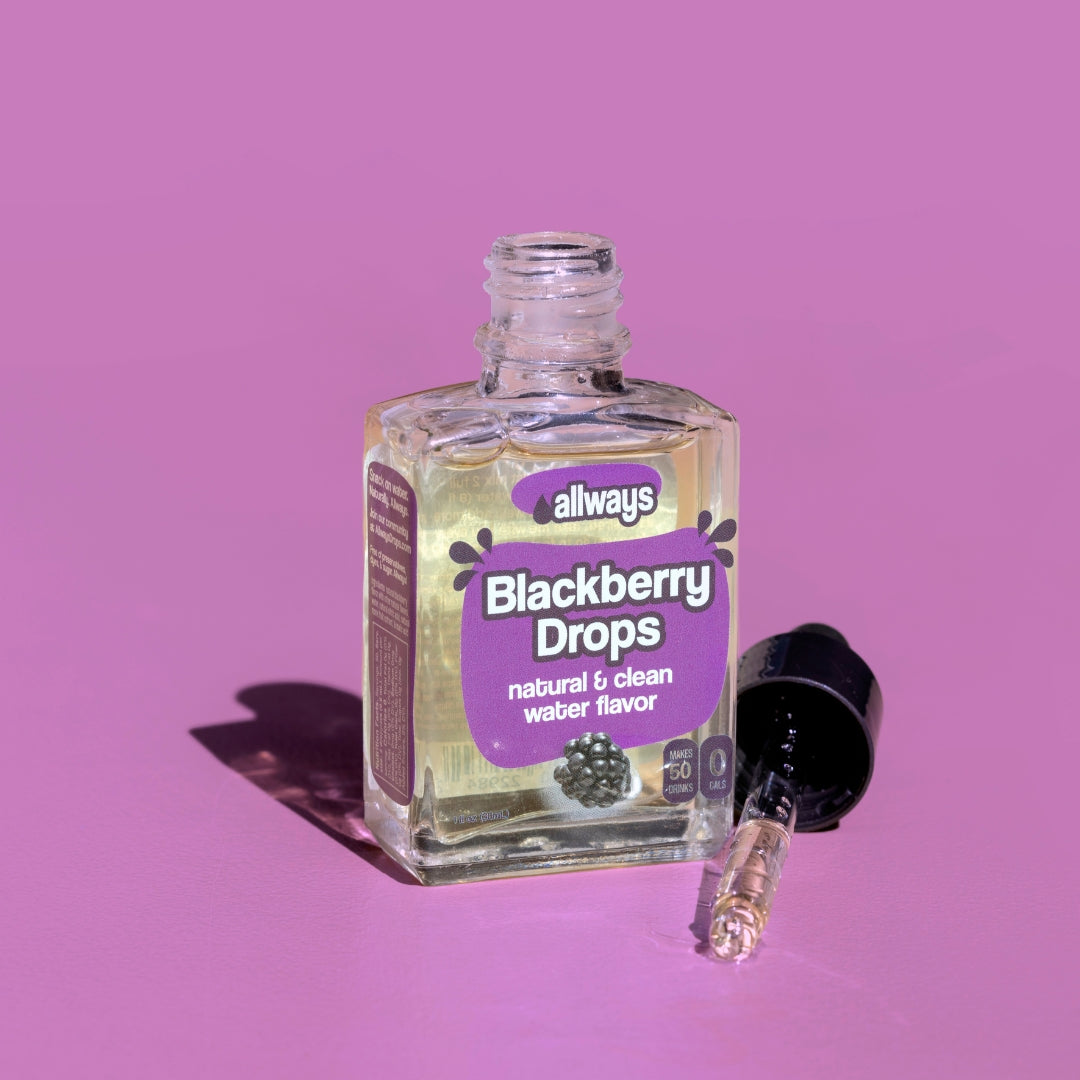 allways blackberry drops in glass bottle with dropper laying next to it in front of a purple background