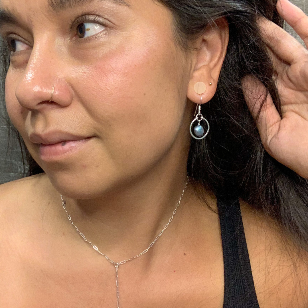 silver earrings with round pendant and blue pearl in the middle