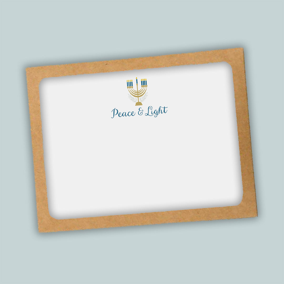 A brown frame with a white background inside, containing a graphic of a menorah with blue and gold accents and the text "Peace & Light" below it.