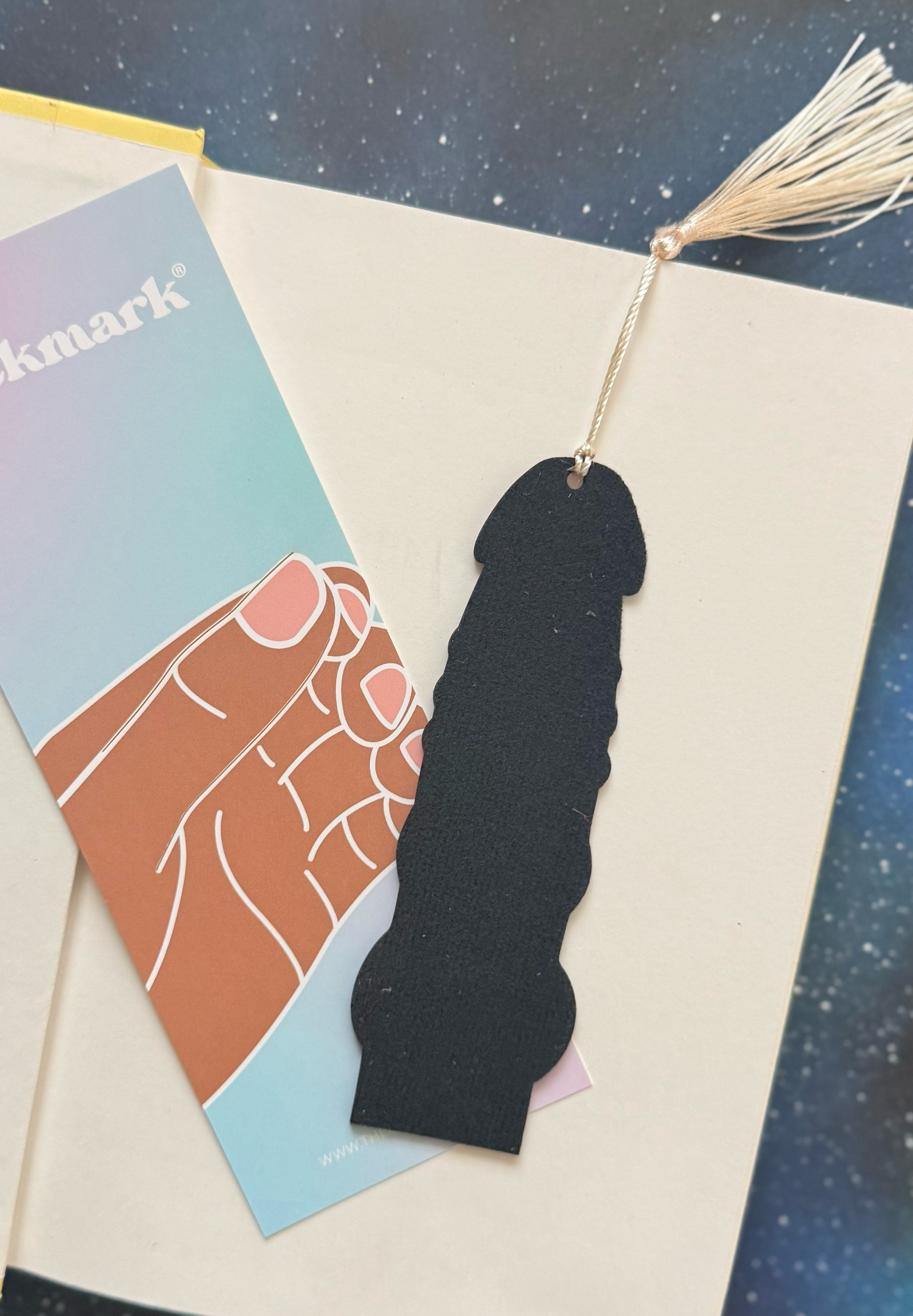 Black silhouette bookmark with tassel on a colorful card