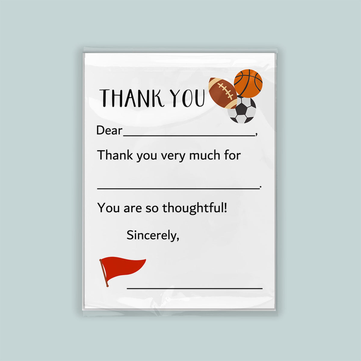 The image is a white thank you card with sports balls and a flag on the front. The card has a blank space for a message and a blank space for a signature.