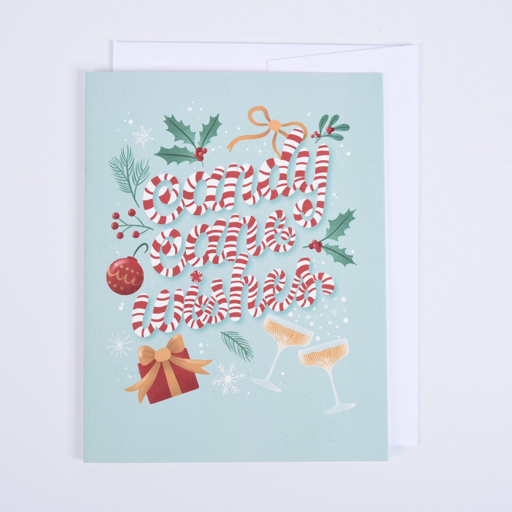 A folded greeting card with a candy cane design and &