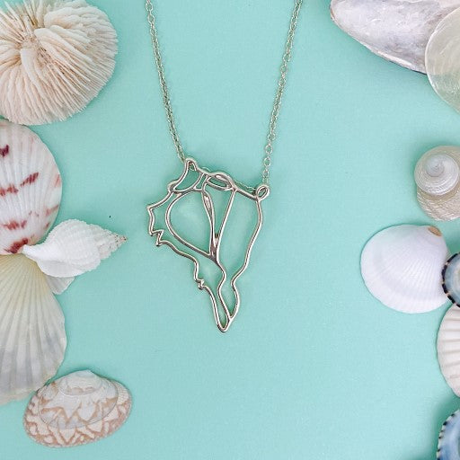 captiva pendant necklaceon turquoise background with mixed shells