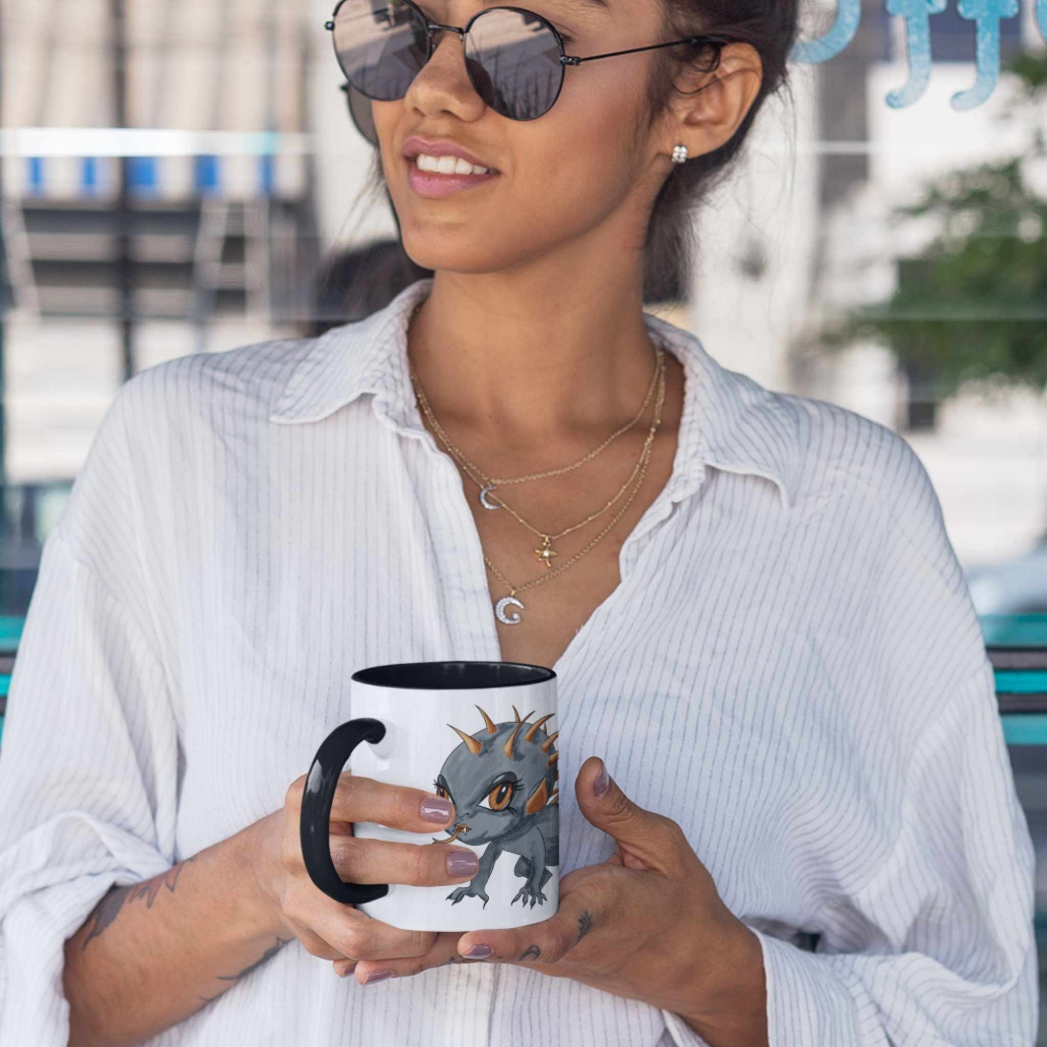 Woman in sunglasses holding the cute Chupacabra cryptid coffee mug outdoors