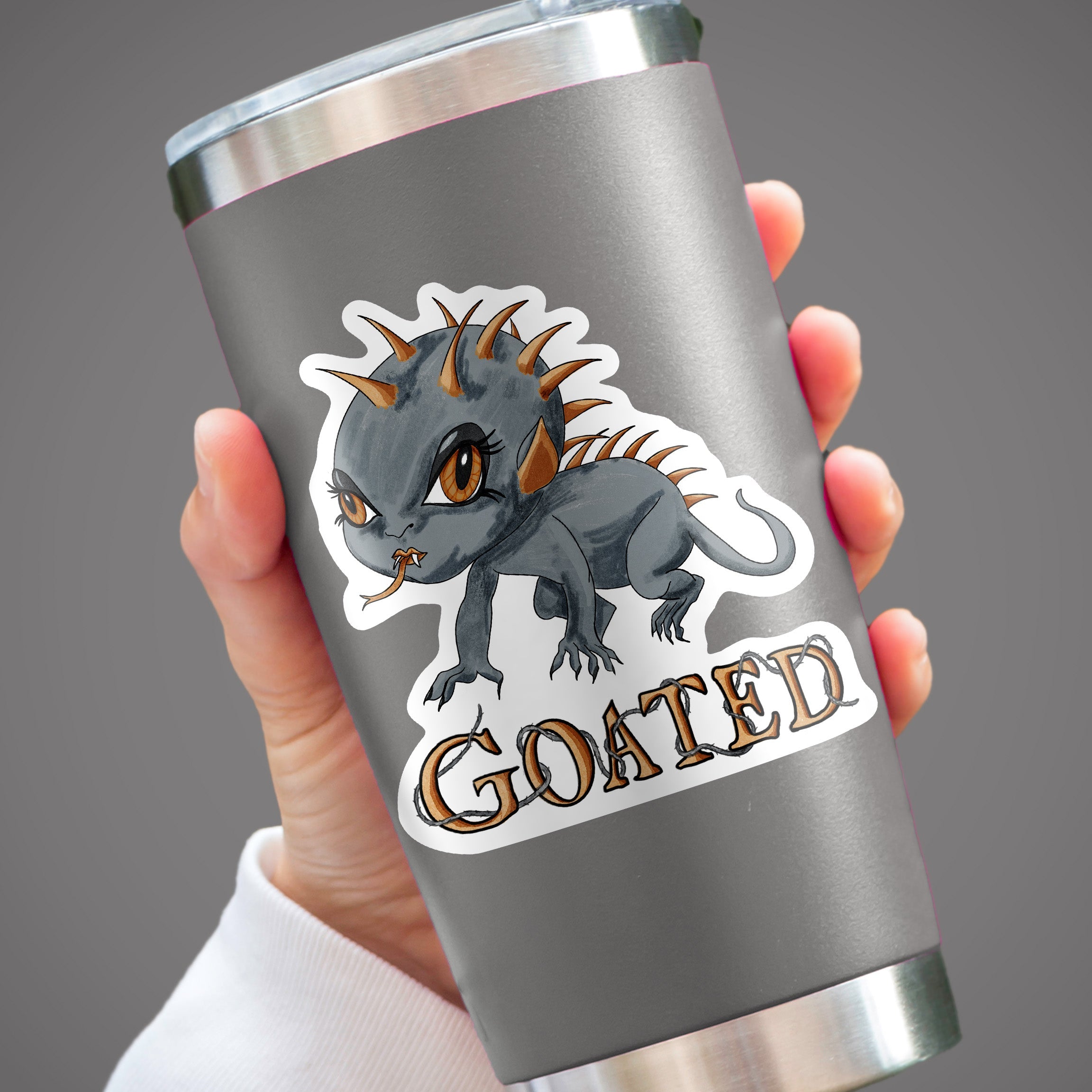 Chibi chupacabra cryptid sticker on a gray insulated tumbler held in one hand