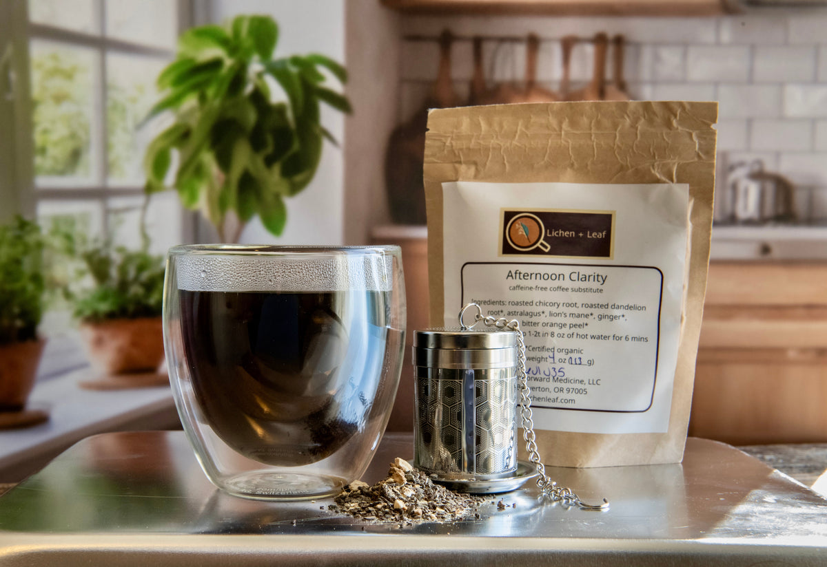 A mug of afternoon clarity resembling coffee alongside the packaging and a strainer