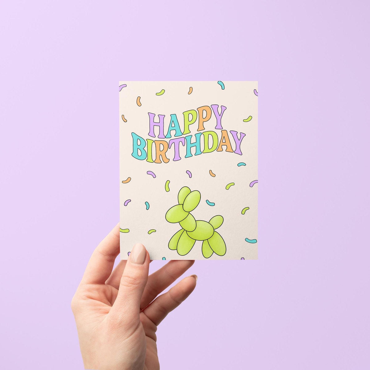 Confetti Happy Birthday card flat lay — bright colorful confetti birthday card styled on a desk, by indie artist MangoIllustrated