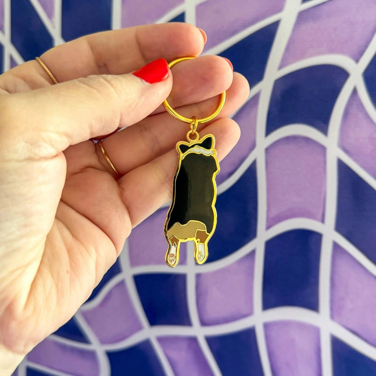 Corgi Sploot enamel keychain — illustrated tricolor corgi splooting on a hard enamel keychain, 1.5 in, by MangoIllustrated