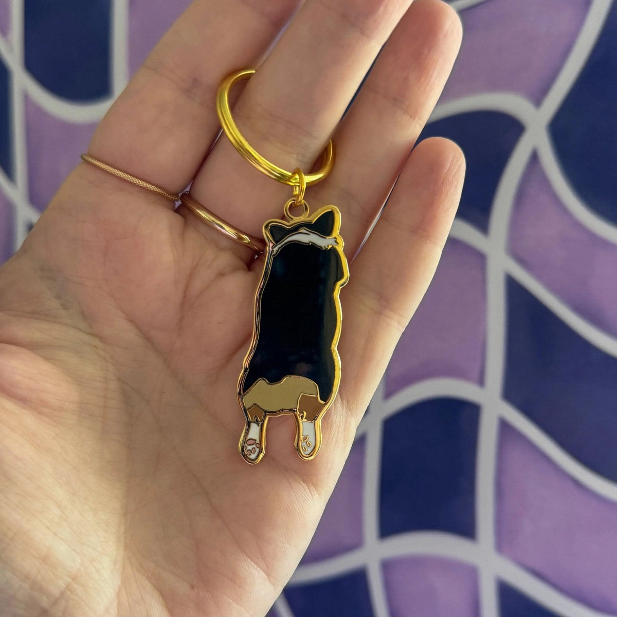Corgi Sploot enamel keychain flat lay — corgi butt enamel keyring on a split ring by indie artist MangoIllustrated