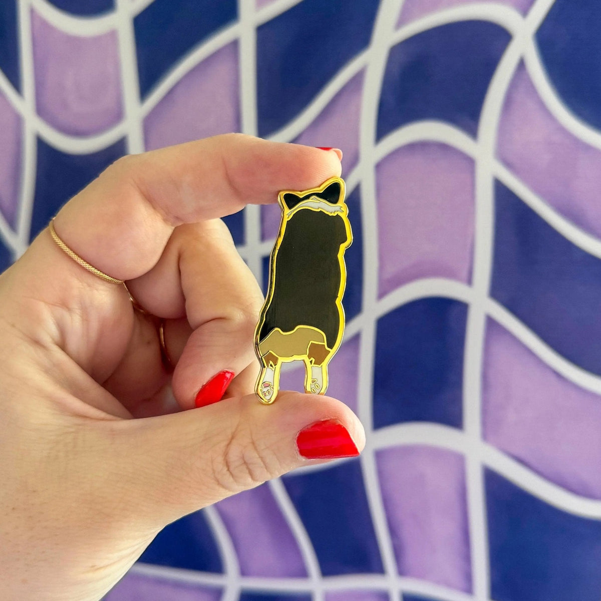 Corgi Sploot enamel pin — illustrated tricolor corgi splooting on a hard enamel pin, 1.5 in, by MangoIllustrated