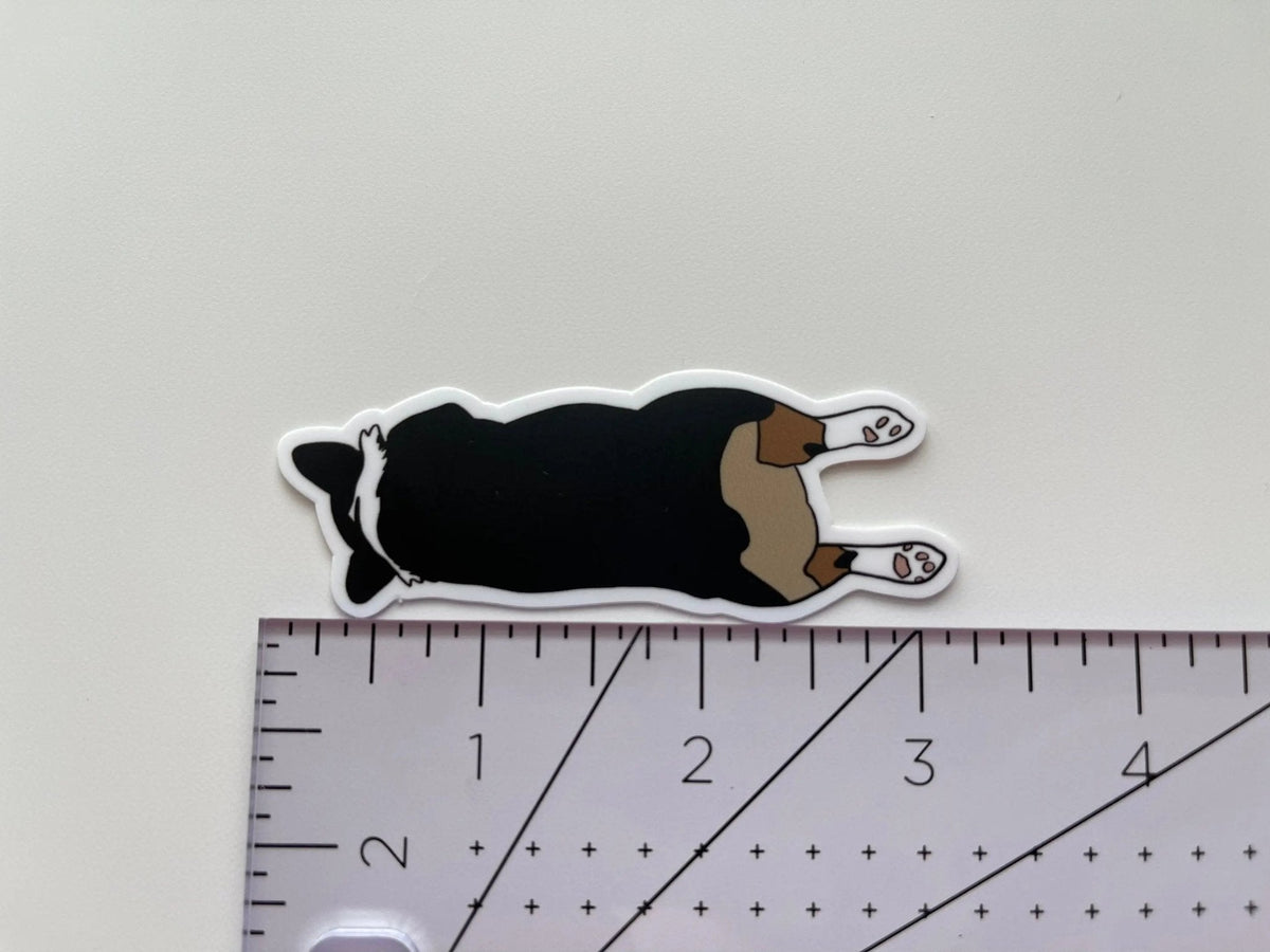 Corgi Sploot sticker flat lay — cute corgi laptop sticker and dog lover gift by indie artist MangoIllustrated