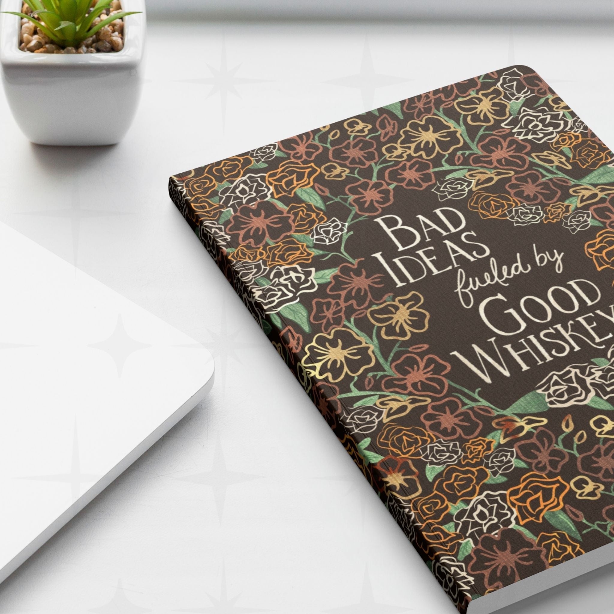 Retro western cowgirl notebook on white desk beside laptop and succulent plant showing full front cover design