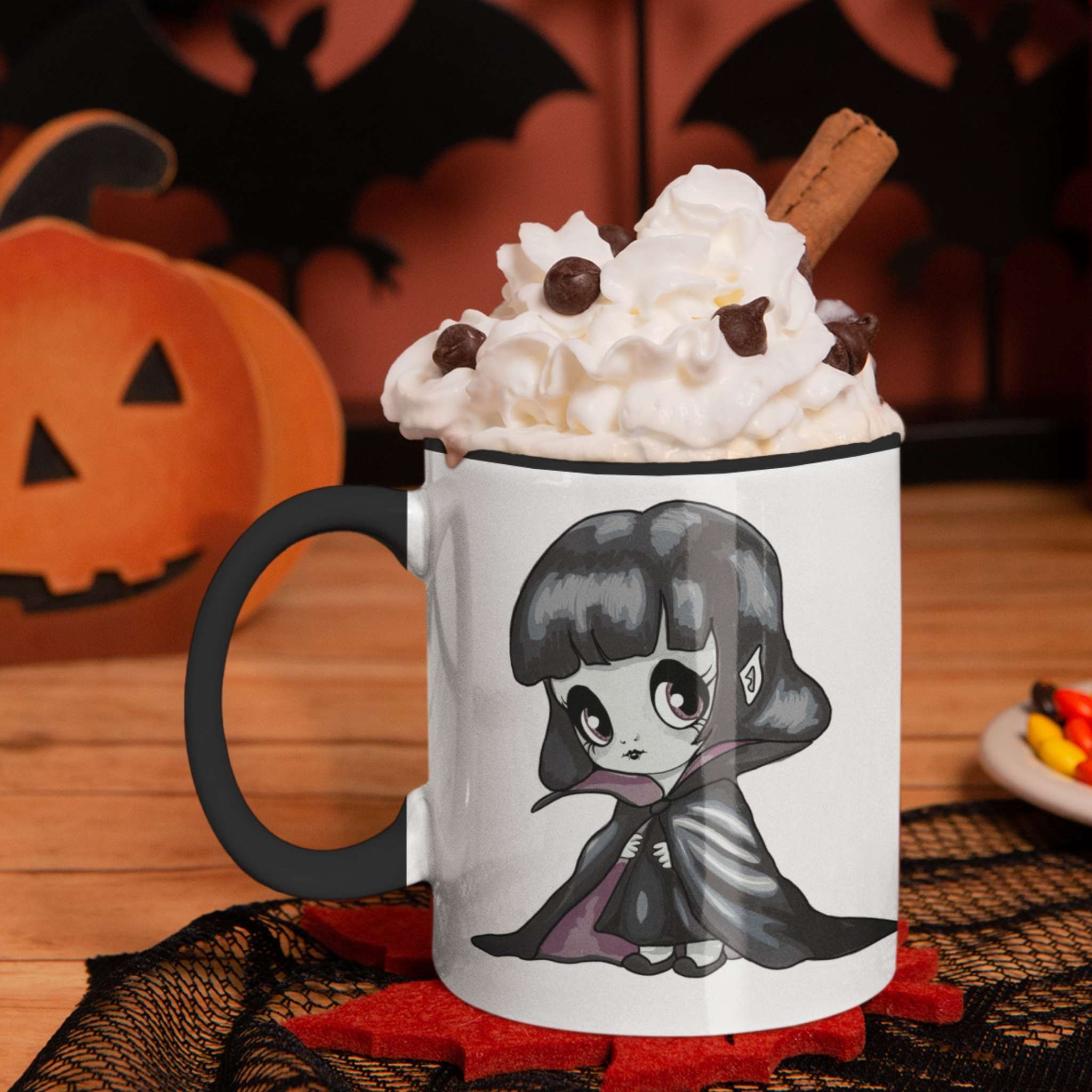 Vampire chibi mug with whipped cream and cinnamon on a Halloween table with pumpkin and bats