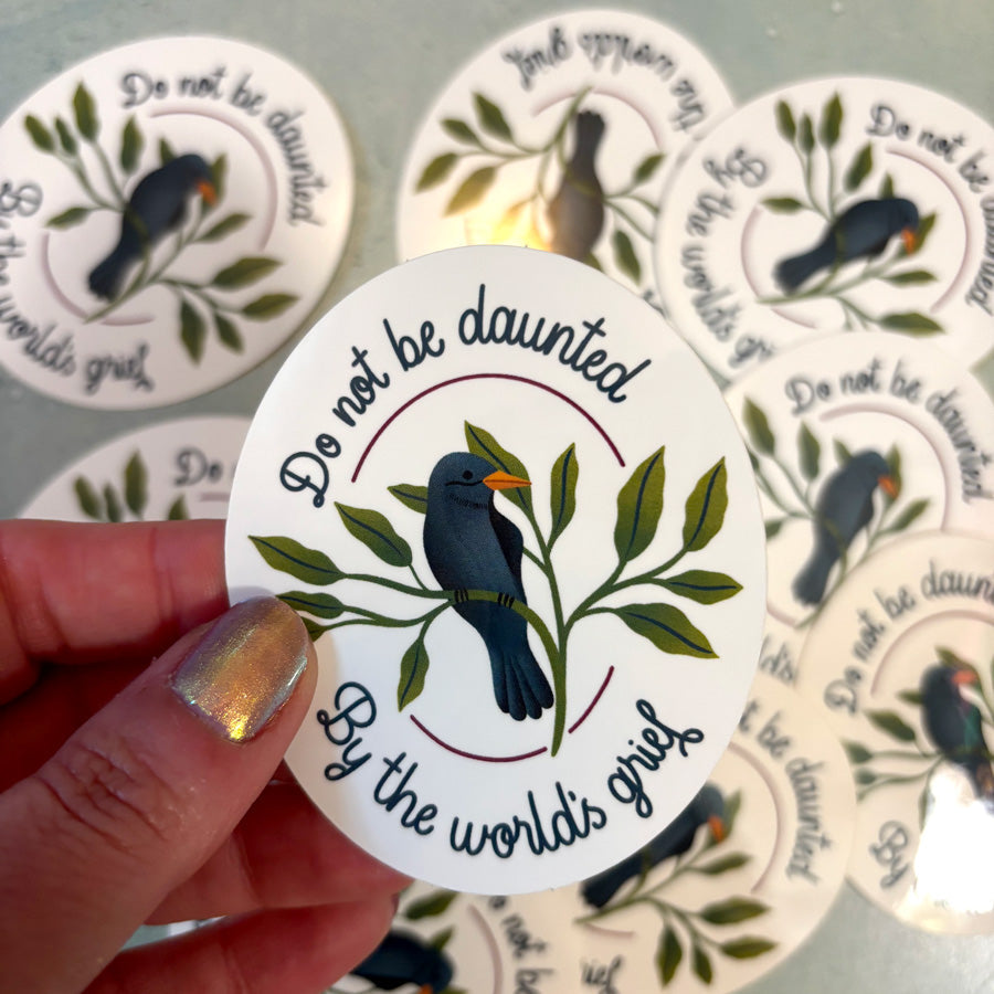 Circular sticker with bird design and text &