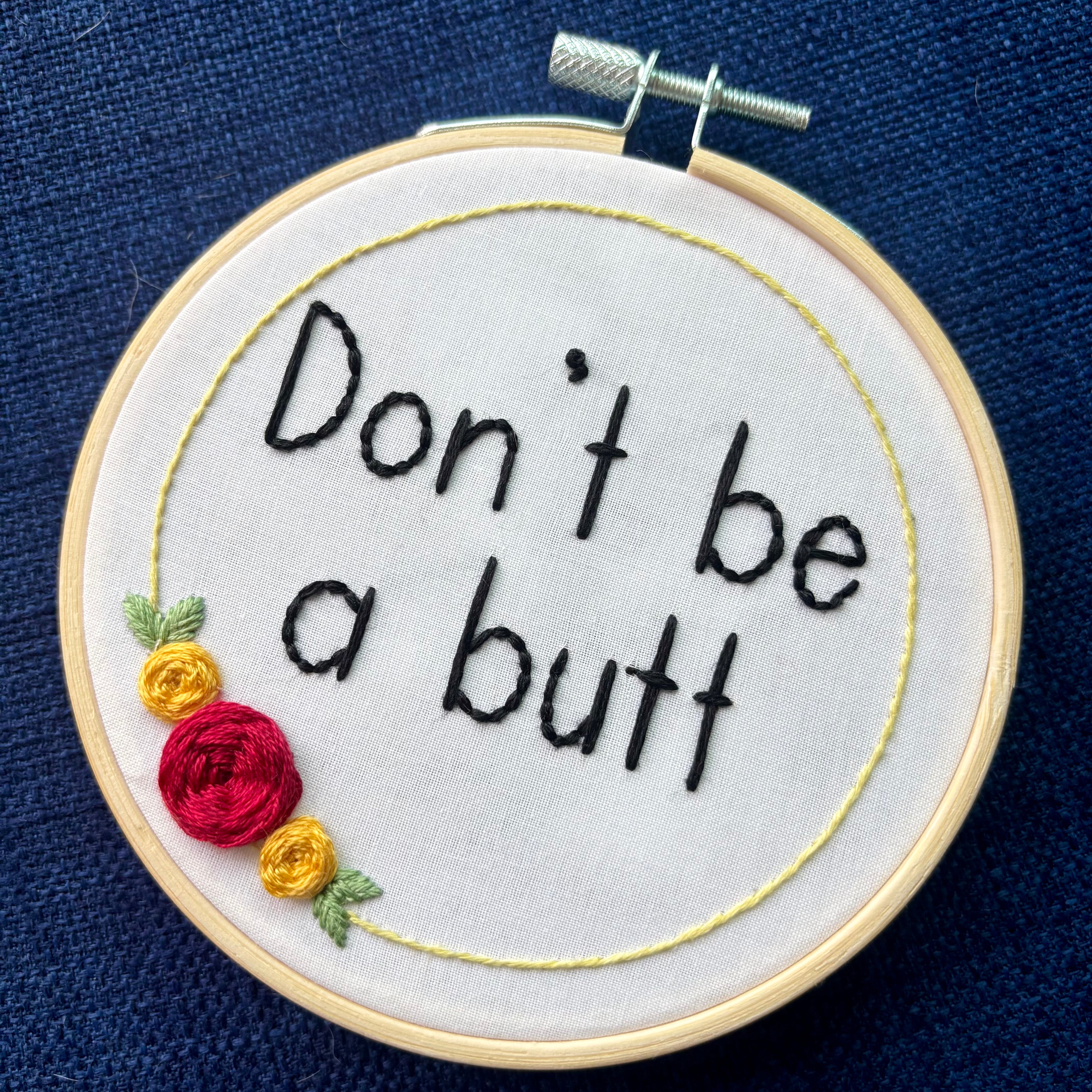 Embroidery hoop reads, "Don&