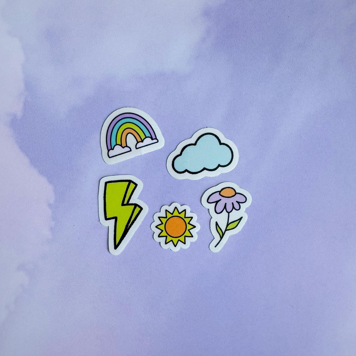 Doodles mini sticker set - lightning bolt, cloud, rainbow, flower, sun flat lay — clear vinyl mini filler stickers by indie artist MangoIllustrated