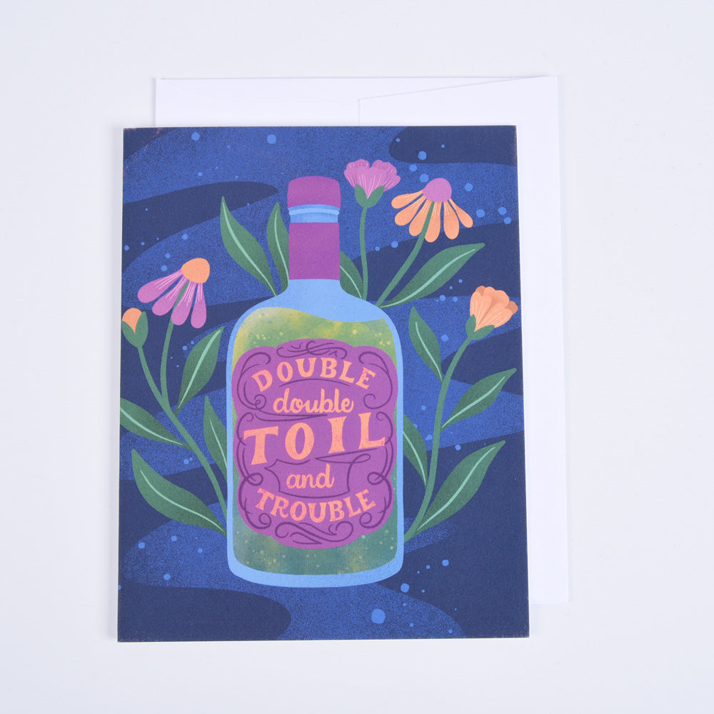 A folded greeting card with a vibrant blue background, featuring a bottle of &